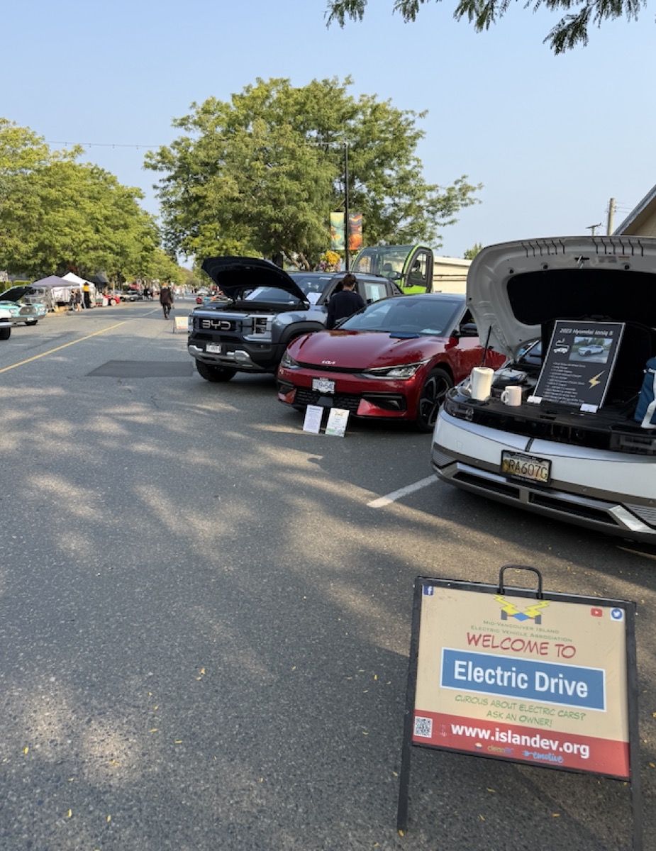 Electric Drive display at the Ladysmith Show & Shine, with a BYD, a red EV, and a white EV on display